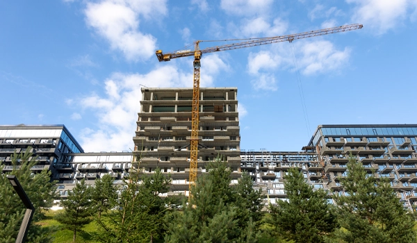 crane infront of empty building with utility disconnection